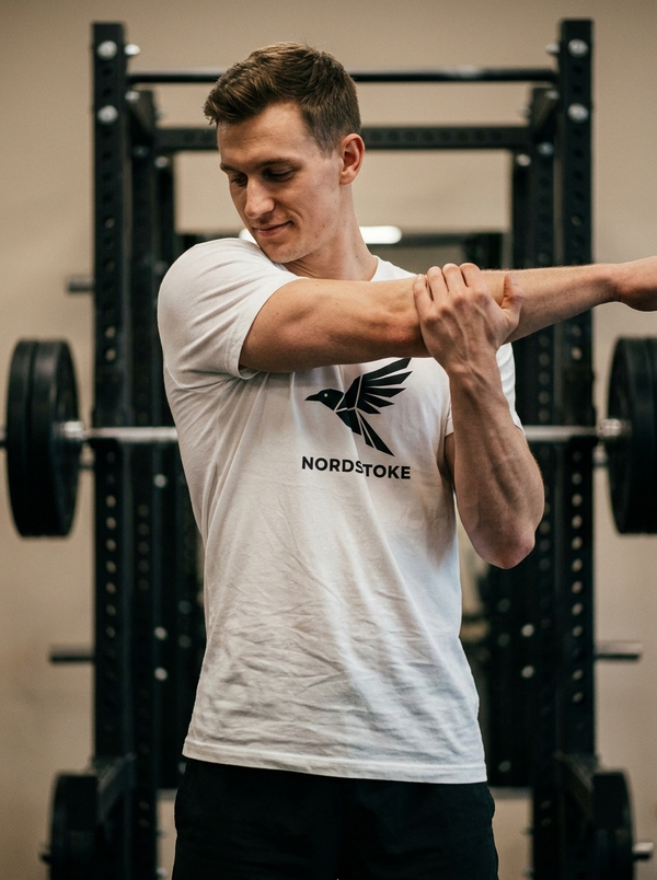 Hybrid athlete wearing the Nordstoke crewneck tee in a gym