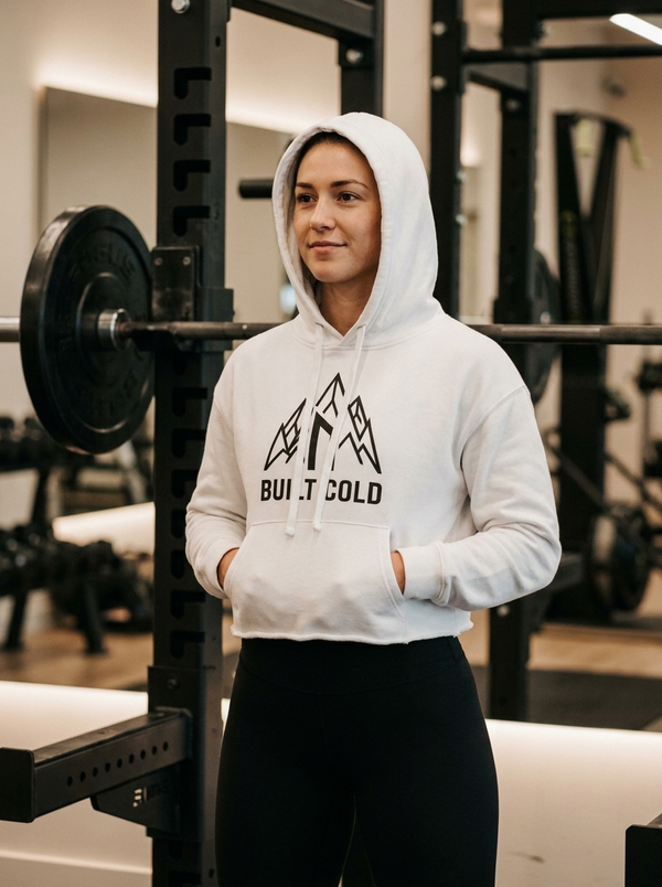 Female hybrid athlete wearing the Nordstoke Built Cold cropped hoodie in a gym