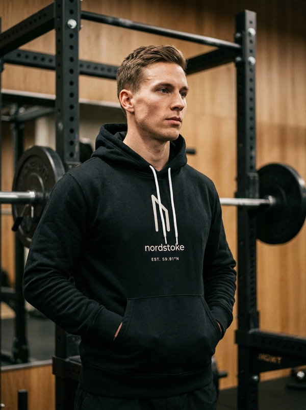 Hybrid athlete wearing the Nordstoke sponge fleece hoodie in a gym