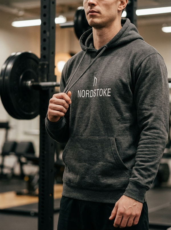Hybrid athlete wearing the Nordstoke premium pullover hoodie in a gym