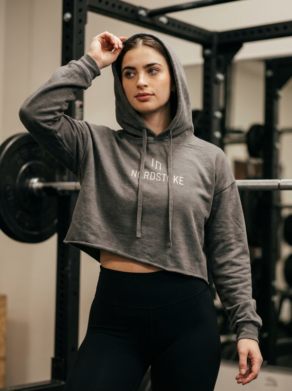 Female hybrid athlete wearing the Nordstoke women's cropped hoodie in a gym