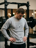 Hybrid athlete wearing the Nordstoke Altitude crewneck with topographic summit print in a gym