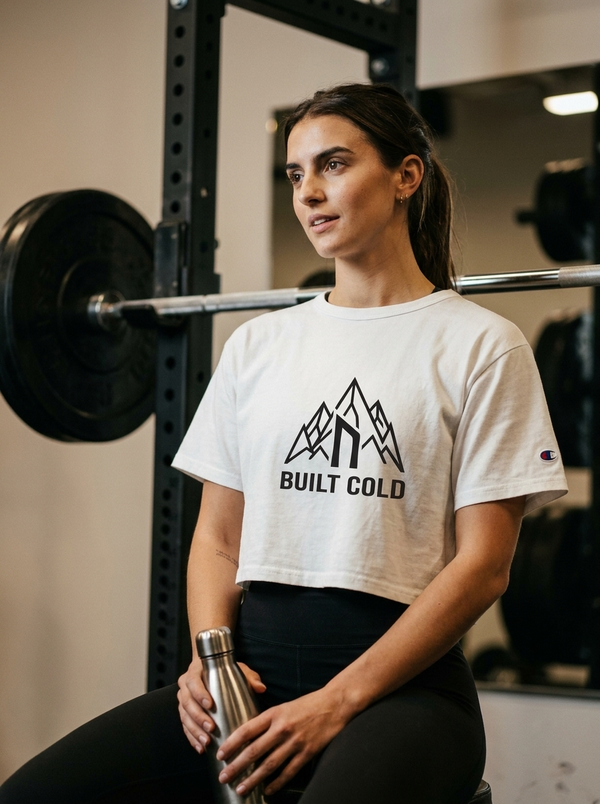 Female hybrid athlete wearing the Nordstoke Built Cold crop tee in a gym