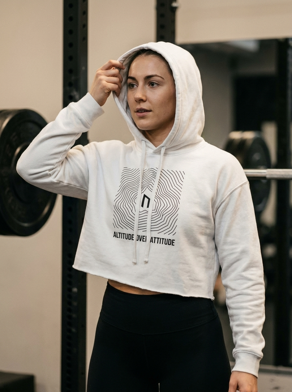Female hybrid athlete wearing the Nordstoke Altitude cropped hoodie in a gym